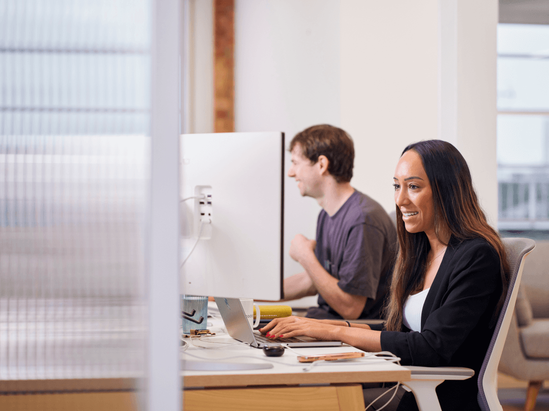 Woman at a desk helping support a D2C merchant